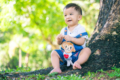 Portrait of a smiling girl sitting on plants