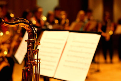 Close-up of saxophone and sheet music during concert