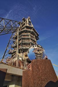 Low angle view of horno alto against blue sky