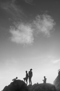 Rear view of silhouette people standing against sky