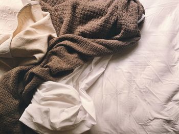 Directly above shot of crumpled blankets on bed