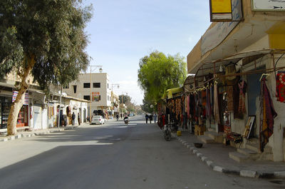 Street amidst buildings in city against sky