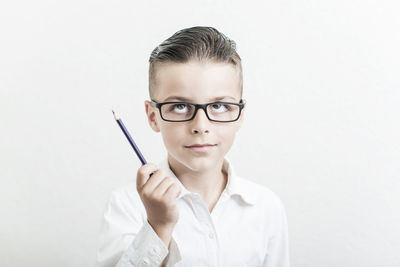 Young woman using mobile phone against white background