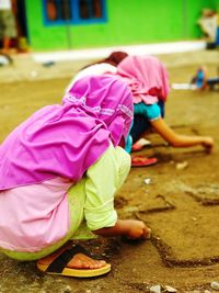 High angle view of girls wearing scarf working on field