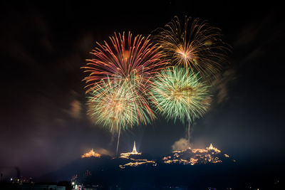 Low angle view of firework display at night