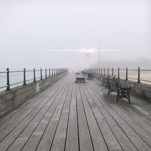 Pier over sea against sky