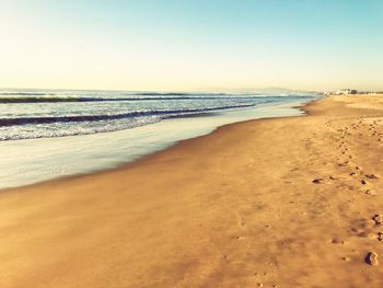 Scenic view of beach against clear sky