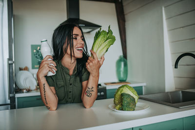 Midsection of woman holding food at home