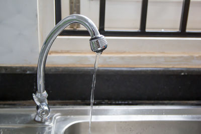 Close-up of faucet in bathroom