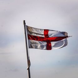 Low angle view of flag against sky
