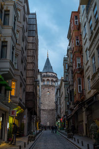 Low angle view of galata tower amidst residential buildings on city