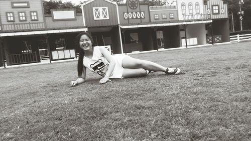 Portrait of smiling young woman sitting on grass