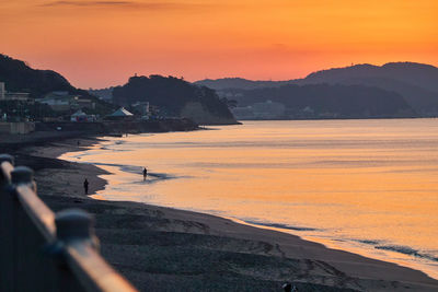 Scenic view of beach against sky during sunset