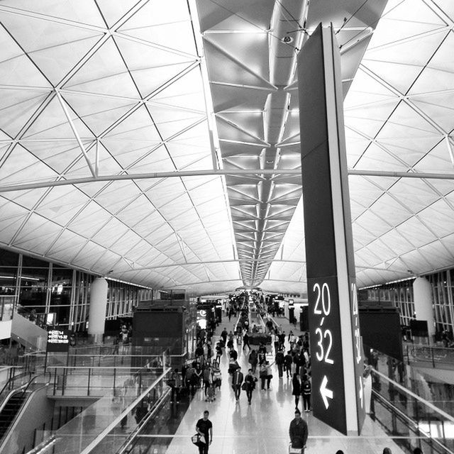 large group of people, indoors, men, lifestyles, person, built structure, architecture, ceiling, leisure activity, walking, modern, railroad station, city life, transportation, travel, airport, shopping mall, public transportation, medium group of people