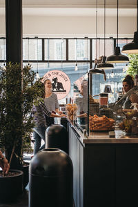 Woman standing by window in store