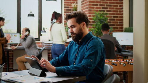 Side view of business colleagues working in office