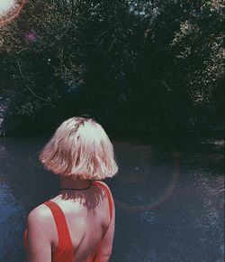 Rear view of woman standing in water