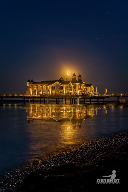 REFLECTION OF ILLUMINATED BUILDINGS IN WATER