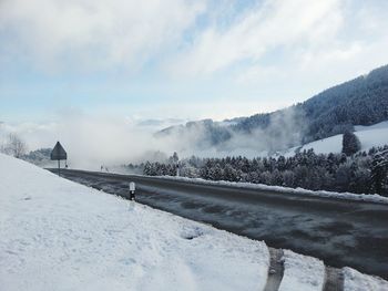 Scenic view of snow covered landscape against sky