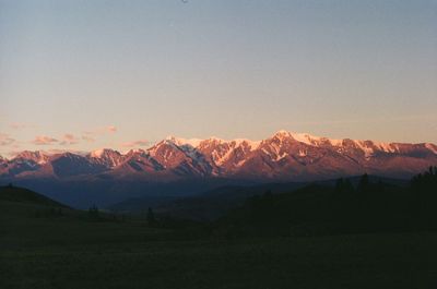 Scenic view of mountains against clear sky during sunset