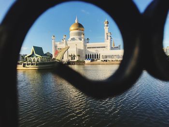 View of mosque and buildings against sky