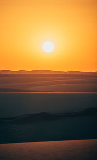 Scenic view of sea against romantic sky at sunset