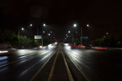 Light trails on road in city at night