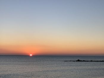 Scenic view of sea against romantic sky at sunset