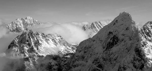 Scenic view of mountains against cloudy sky