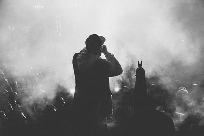 Rear view of singer performing in front of audience