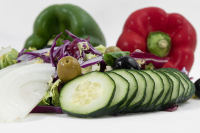 Close-up of fruits in plate against white background