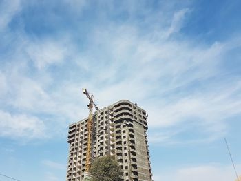 Low angle view of building against cloudy sky