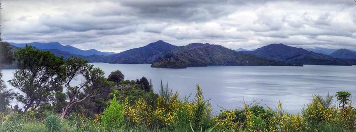 Scenic view of lake and mountains against sky