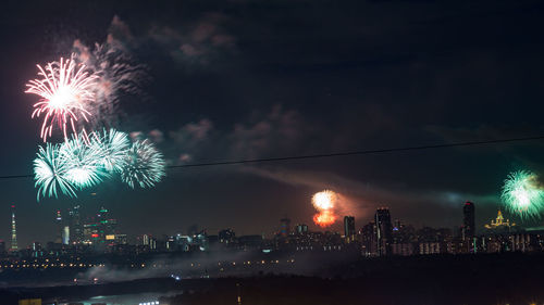 Firework display over city at night