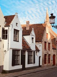 Low angle view of houses in town against sky
