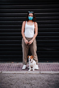 Full length of teenage girl with dog