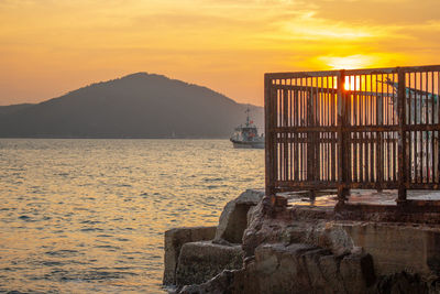Scenic view of sea against orange sky