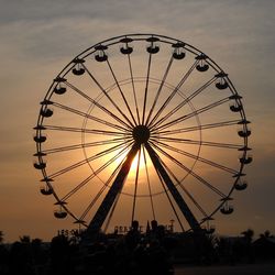 Silhouette ferris wheel against sky during sunset