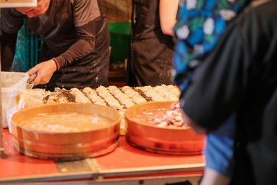 Midsection of man preparing food