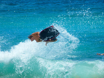 People surfing in sea