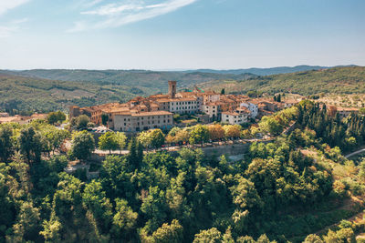 Scenic view of trees and buildings against sky