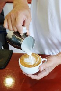 Midsection of man holding coffee