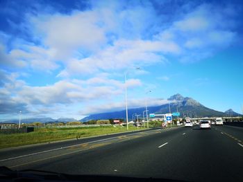 Road passing through landscape against sky