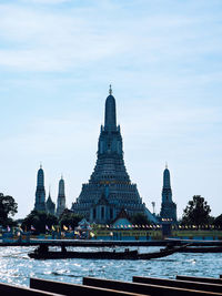 Temple by building against sky