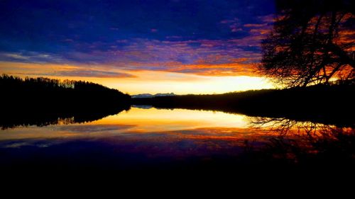 Scenic view of lake against romantic sky at sunset