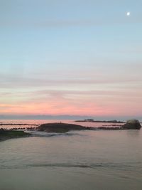 Scenic view of sea against sky at sunset