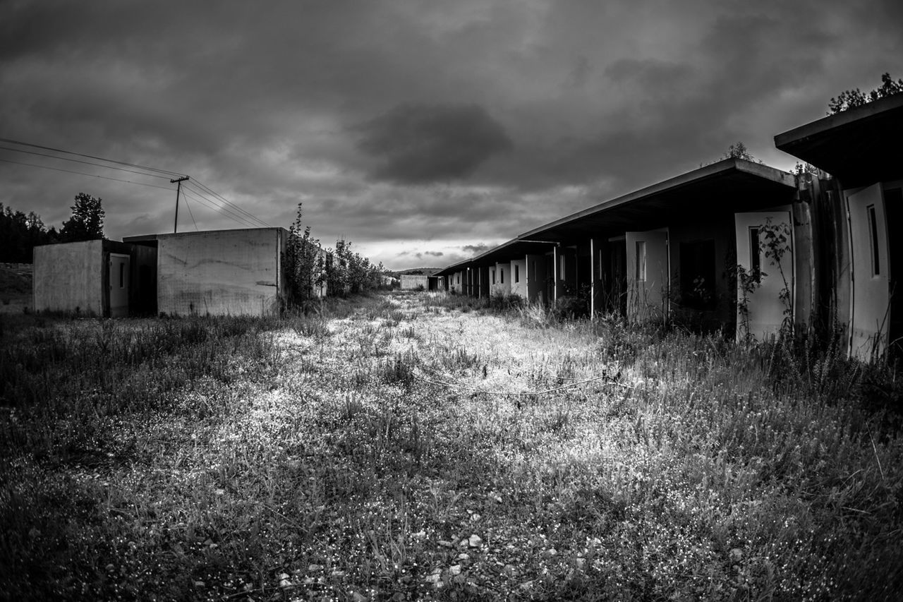 architecture, building exterior, built structure, sky, cloud - sky, house, field, grass, cloudy, cloud, plant, rural scene, landscape, residential structure, growth, nature, overcast, barn, outdoors, weather