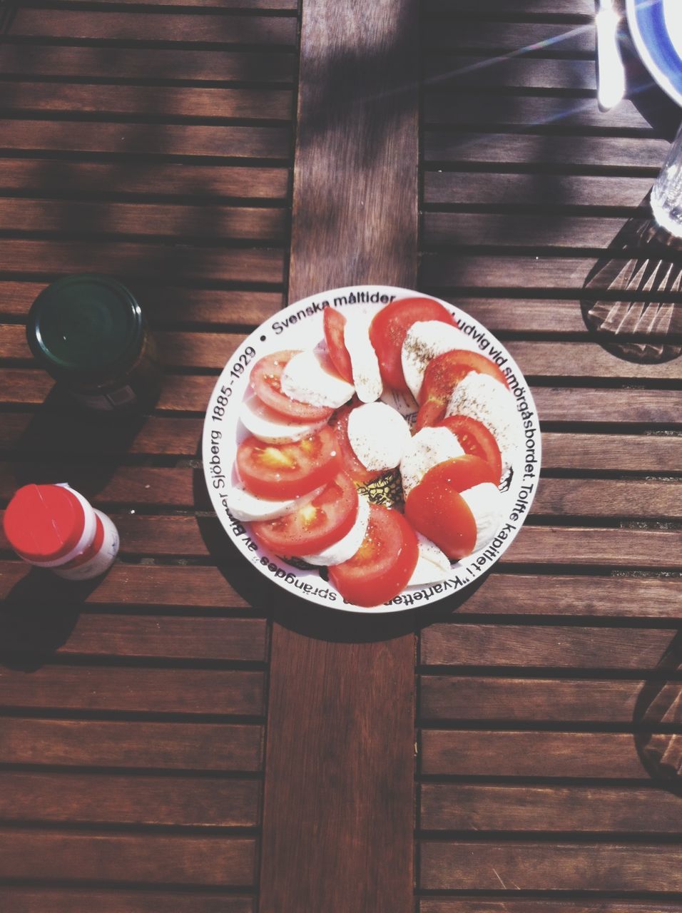 food and drink, table, indoors, wood - material, food, freshness, still life, wooden, high angle view, plate, ready-to-eat, directly above, indulgence, red, heart shape, sweet food, close-up, drink, bowl, wood