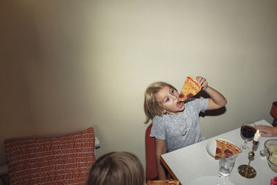 Girl at table eating pizza