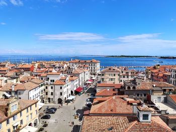 High angle view of townscape by sea against sky